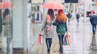 Shoppers in the rain