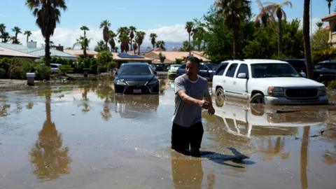 A man returns to his home through a flooded street after Tropical Storm Hilary passed Cathedral City, California, US, on 21 August 2023