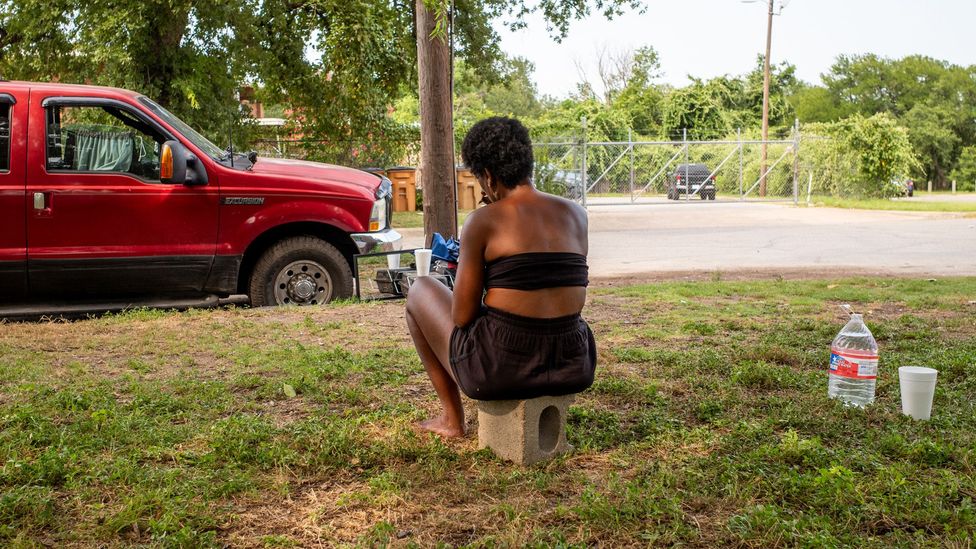 Stephenie Carrie sits in the shade in June, 2023 in Austin, Texas. Communities of colour often experience higher temperatures than white neighbourhoods (Credit: Getty Images)
